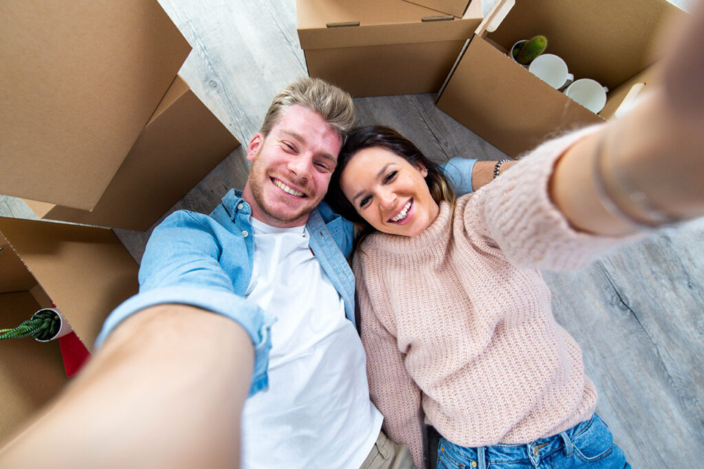 Couple laying on floor with moving boxes